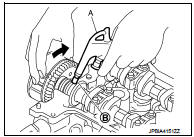 c. Hold the camshaft sprocket (INT) with hands, and then apply the power