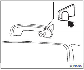 The coat hook is located above the rear side window.
