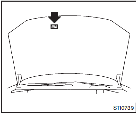 The emission control information label is attached to the underside of the hood