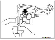 4. Tilt the reservoir tank so that a mounting pin can be inserted. Insert a