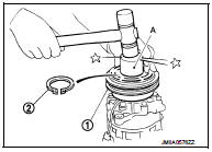 4. Install clutch disc on drive shaft, together with original shim(s). Press