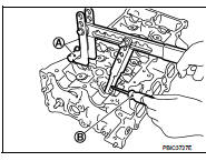 4. Remove valve spring retainer and valve spring.