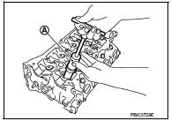 7. Remove valve spring seat.
