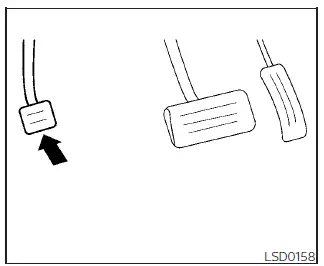 Location and mechanical engagement layout of the foot-actuated parking brake pedal in the driver footwell area