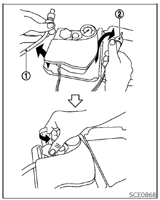 Removing the air compressor hose and power plug from the Nissan Leaf repair kit